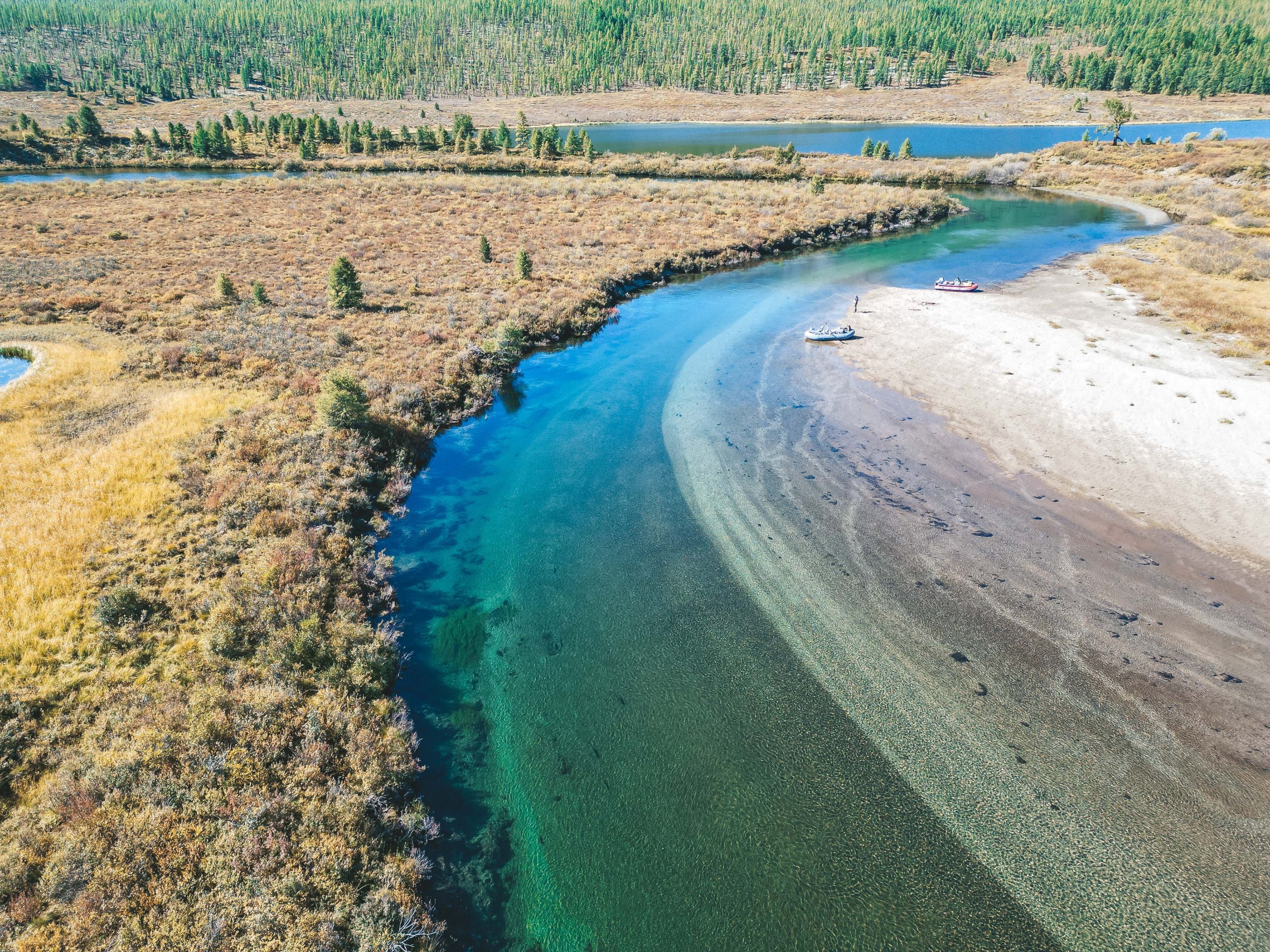 Aerial view of rafts on a river bend