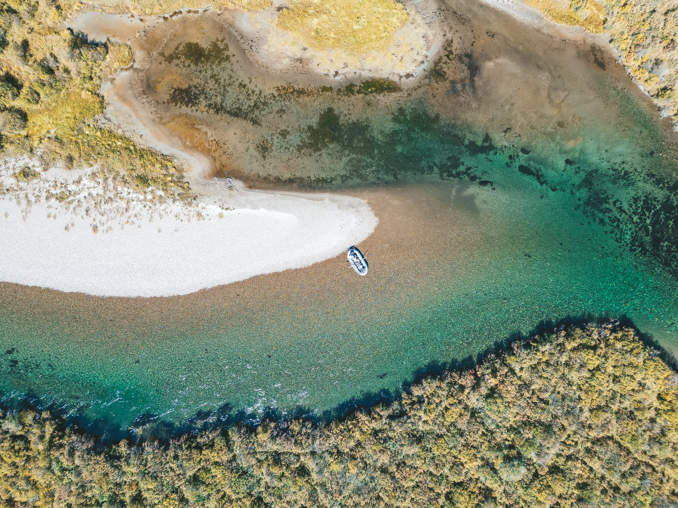 Aerial view of a raft beside a gravel bank