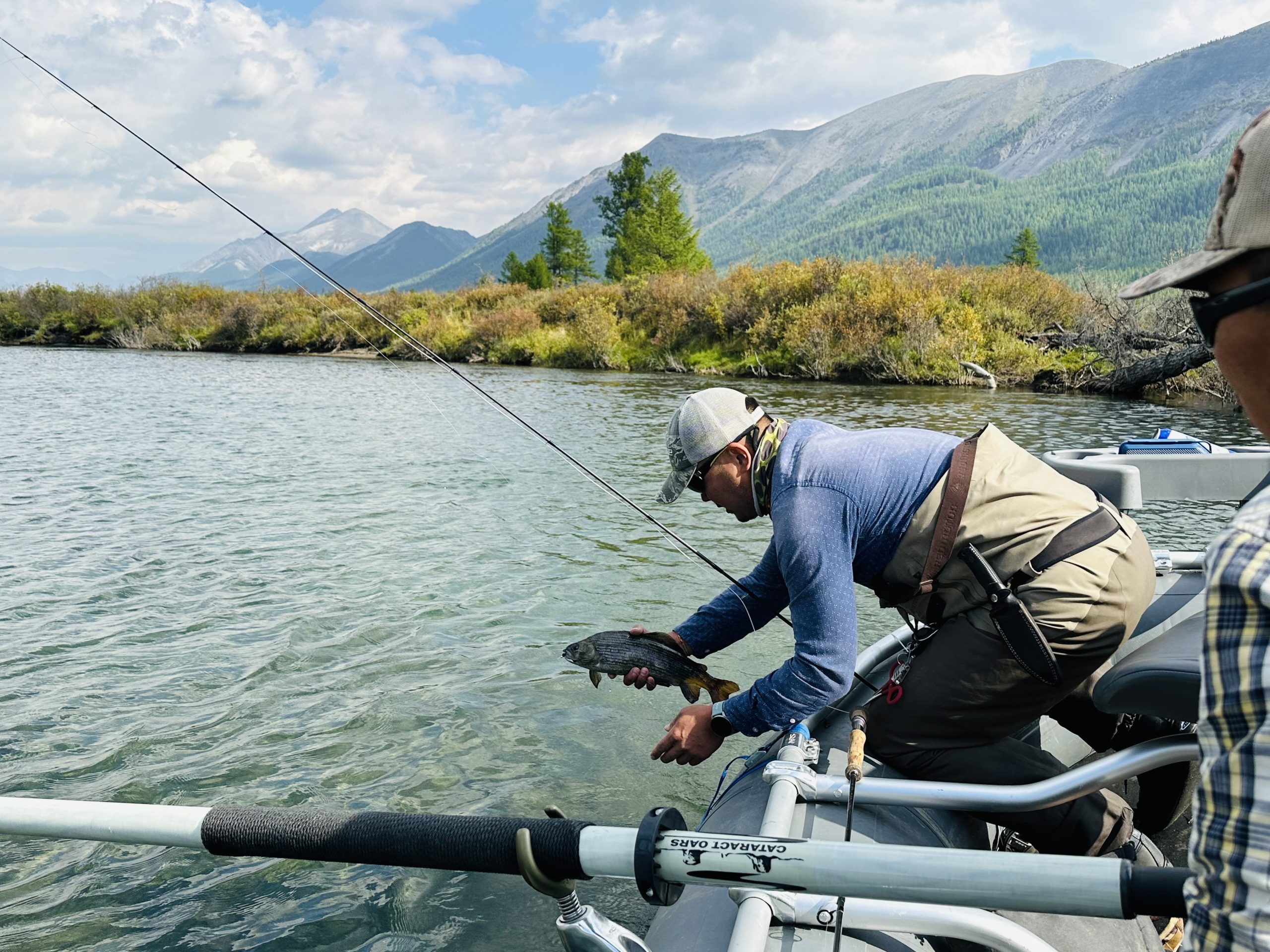 Angler releasing a fish from the raft