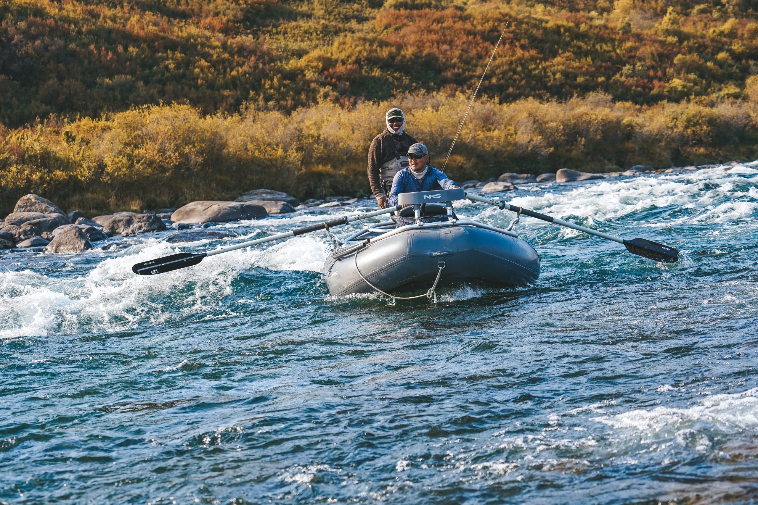 Rafting through mountain river rapids